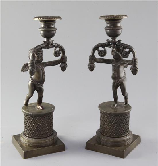 A pair of early 19th century bronze candlesticks, 10in.